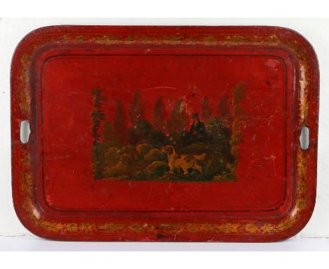 Large 19th Century Toleware tray, with a spaniel hunting while his owner stands behind in foliage on a red ground and foliate