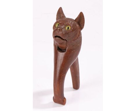 19th Century nutcracker, of a cat carved in soft wood with big bright yellow glass eyes, 16.5cm long