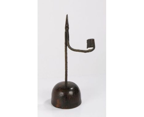English rush light and candle holder, circa 1800, the wrought iron arm with candlestick socket above the domed oak base, 30cm