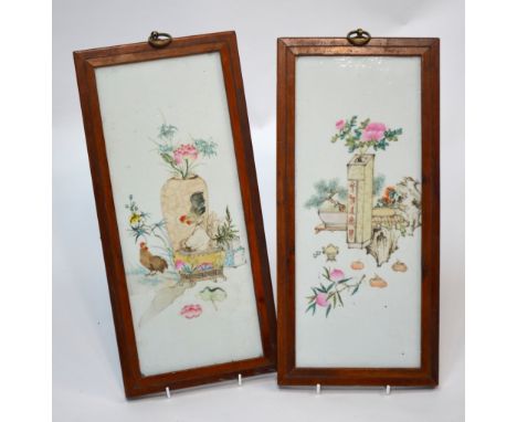 A pair of famille rose plaques, each one decorated with a flower arrangement from a Scholar's studio, wood frame and suspensi