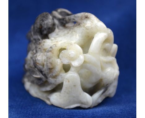 A mottled grey, white and black jade hat finial decorated with a Natural History design, 3.5cm long Condition Report No easil