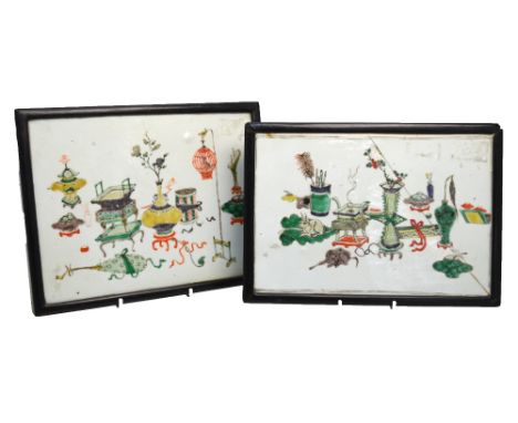 An associated pair of rectangular famille verte stands or plaques; each one decorated with Scholar's utensils and archaic ves