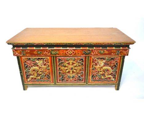 A Tibetan or Himalayan rectangular puja, decorated in scarlet, gilt and other enamel with a central dharma chakra, panels of 