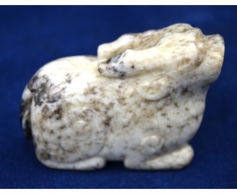 A mottled grey/white jade carved as a mythological animal, 5cm long