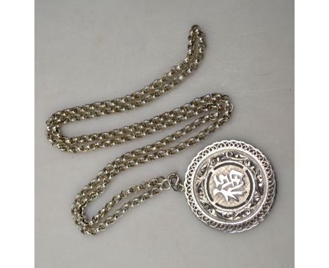 A Chinese white-metal circular pendant with single character on both obverse and reverse; with associated white metal chain; 