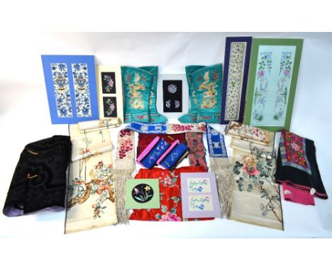 A quantity of Chinese textiles, including: a long black waistcoat decorated with Buddhist or other sacred symbols; a skirt wi