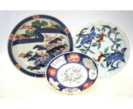 Three Japanese Imari dishes: one decorated in underglaze blue, green enamel and typical colours with a pine clad village land