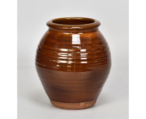Attributed to BERNARD LEACH (1887-1979) for Leach Pottery; a slipware jar with pronounced ribbing covered in treacle glaze, i