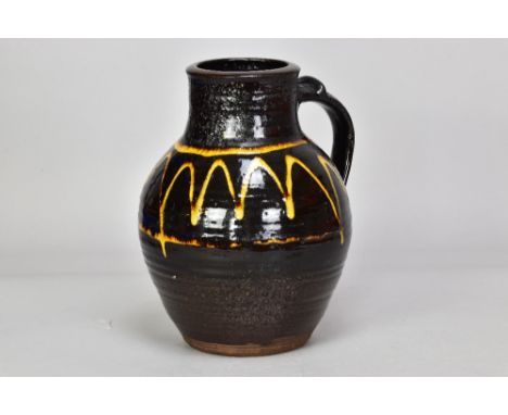 MICHAEL CARDEW (1901-1983) for Winchcombe Pottery; a slipware jug with trailed decoration on black ground, impressed MC and p