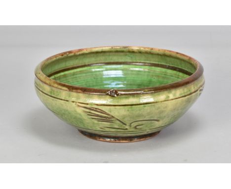 Attributed to MICHAEL CARDEW (1901-1983) for Winchcombe Pottery; a slipware bowl covered in green galena glaze with simple ir