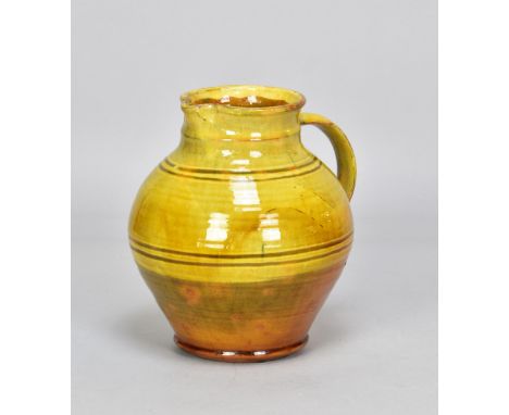 Attributed to MICHAEL CARDEW (1901-1983) for Winchcombe Pottery; a slipware jug with faint iron meander decoration on yellow 