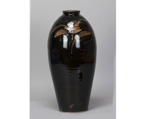 DAVID LEACH (1911-2005) for Lowerdown Pottery; a tall stoneware bottle covered in tenmoku glaze with foxglove motif picked ou