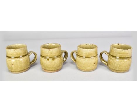 RICHARD BATTERHAM (born 1936); a set of four small stoneware mugs covered in green ash glaze, heights 8cm (4). (D)Additional 