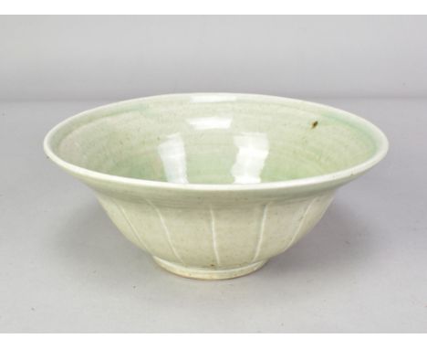TREVOR CORSER (1938-2015) for Leach Pottery; a fluted porcelain bowl covered in pale green glaze, impressed TC and pottery ma