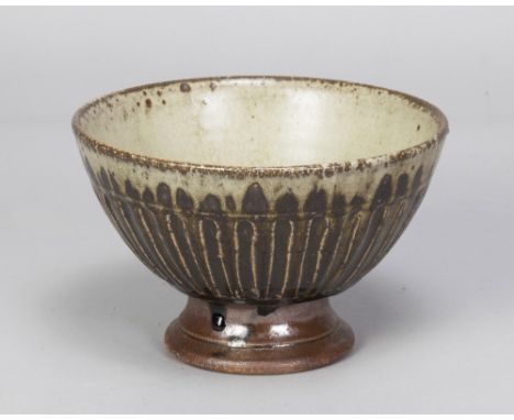 RICHARD BATTERHAM (born 1936); a fluted stoneware pedestal bowl with green ash glaze pooling to the well, diameter 18cm. (D)A