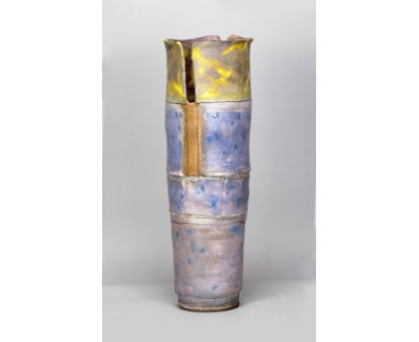 ROBIN WELCH (1936-2019); a tall tapered stoneware vessel with pierced top and bands of yellow and blue glaze and enamel spots