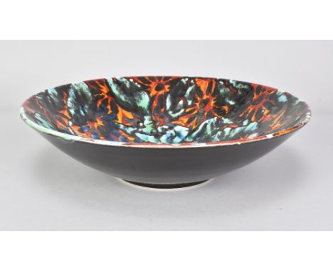 JANICE TCHALENKO (1942-2018); a large stoneware bowl with bright polychrome floral decoration to the interior, exterior glaze