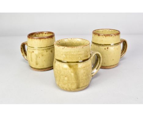 RICHARD BATTERHAM (born 1936); three stoneware mugs covered in green ash glaze, heights 10cm (3). (D)Additional InformationRi