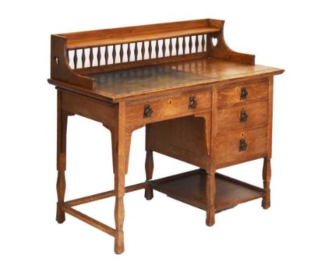 Shapland &amp; Petter, Barnstaple, Arts and Crafts oak desk, circa 1900, the superstructure with shelved spindle filled galle