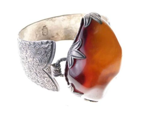 Helmut Kleist bangle with stamped marks and '925' set with a large amber boulder, engraved decoration, internal diameter appr