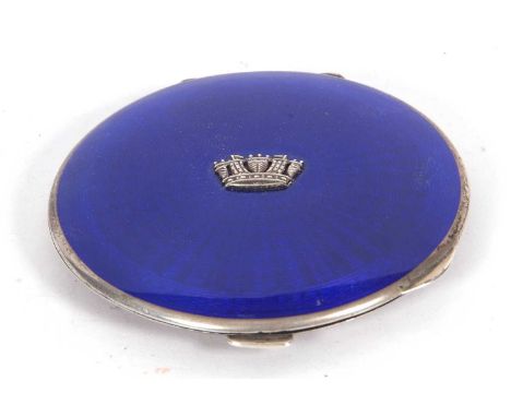 George V circular powder compact, the blue enamelled lid with crown insignia to the centre, engine turned back, 8cm diameter,