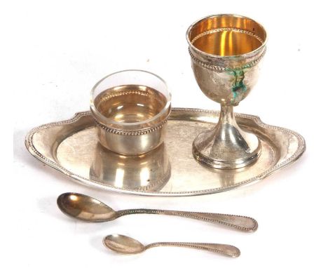 An early/mid 20th Century German silver cased breakfast set comprising small beaded edged oval tray, egg cup, salt with clear