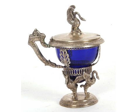Continental white metal mustard pot with swan supports, the mustard pot with an open work leaf frame having a hinged lid with