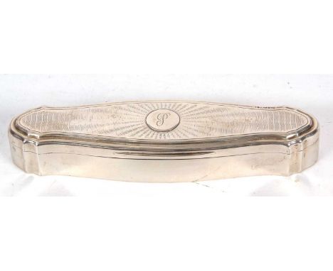 A George V silver trinket box of shaped elongated form, the hinged lid with engine turned decoration around a circular cartou