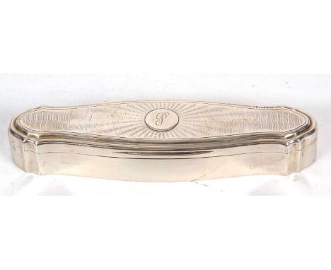 A George V silver trinket box of shaped elongated form, the hinged lid with engine turned decoration around a circular cartou