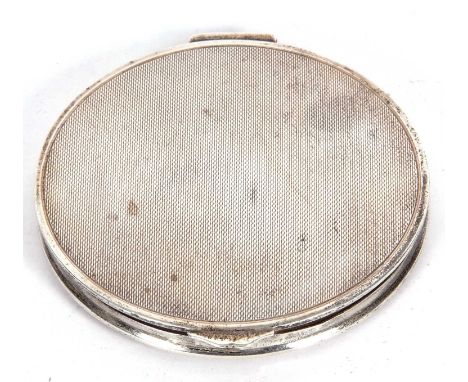 A large George VI circular powder compact with engine turned lid and base,  mirror within, 10cm diameter, Birmingham 1949 by 