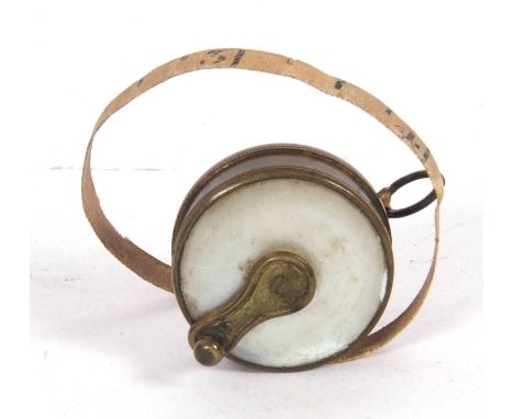 Late 19th/early 20th Century brass and mother of pearl mounted dress makers tape measure (3 ft), 2.5cm diameter