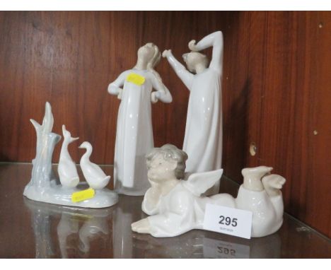 Three Lladro figurines together with a Nao example 