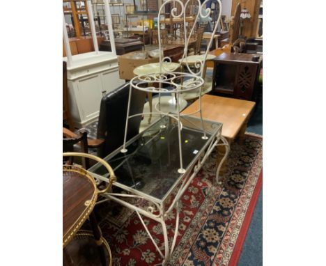 A vintage wrought iron coffee table with glass top together with a chair 