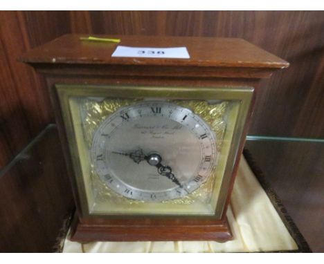 A small Garrard mantle clock together with a cased set of knifes
