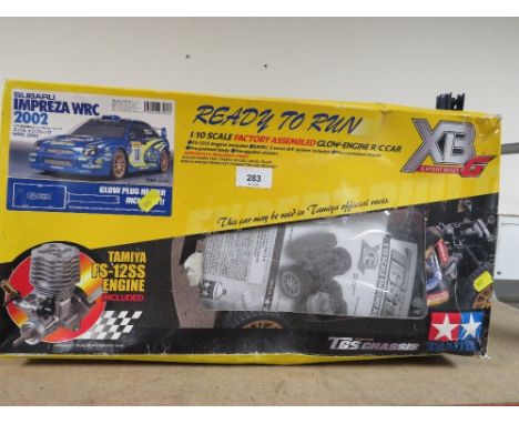 A boxed Tamiya petrol remote control Subaru car, 1/10 scale (unchecked)