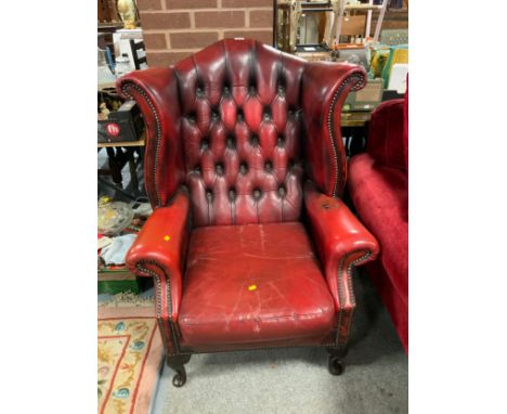 A vintage ox blood red leather wing armchair A/F 