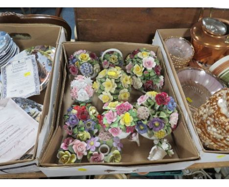 A tray of assorted Wedgwood and Doulton collectors plates many with certificates together with a tray of ceramic posies and a
