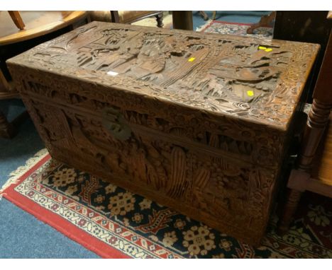 A vintage carved camphor wood eastern blanket box W 104 cm together with a tall table having single drawer (2)