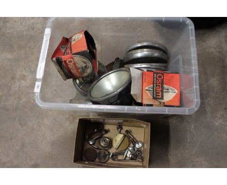 A tub of vintage motor spares to include hub caps, pair of boxed Osram headlight bulbs, headlights, radiator caps, petrol cap