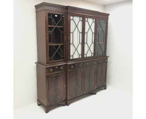 Georgian style mahogany breakfront bookcase, projecting cornice, dentil frieze, four doors above four drawers and cupboards, 