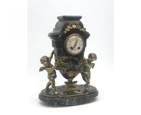 Late 20th century green marble mantel clock, urn shaped with circular Arabic dial, two gilt winged putti either side, floral 