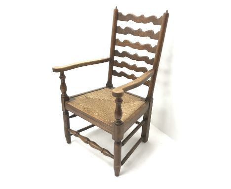 Early 20th century oak fireside armchair, shaped ladder back, reeded drop in seat, turned supports joined by stretchers, W59c