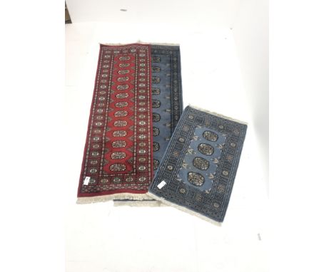 Bokhara blue ground runner, repeating border (195cm x 62cm), a matching blue ground matt and  a Bokhara red ground rug (186cm