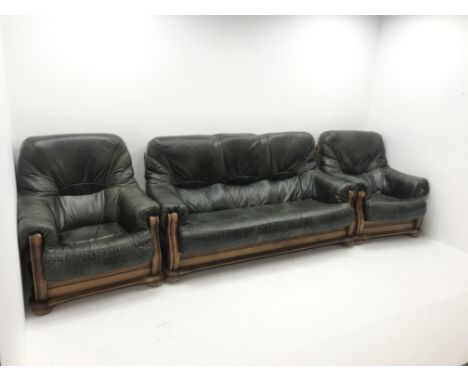 Three seat oak framed sofa upholstered in dark green leather (W180cm) and two matching armchairs (W90cm) - Condition Report 