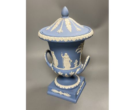 A 20th century Wedgwood light blue jasperware two-handled campagna-shaped urn and cover, decorated with foliage and a frieze 