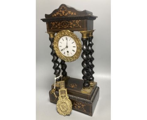 A 19th century French portico ebonised mantel clock, enamelled dial and timepiece movement, gridiron pendulum, 44cm high