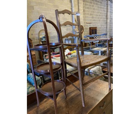 An Arts &amp; Crafts ladder-back rush-seat elbow chair and an Edwardian inlaid mahogany three-tier cake stand (faults), 96cm 