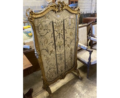 A 19th century Louis XV style giltwood fire screen having embroidered silk panel, width 85cm, height 142cm