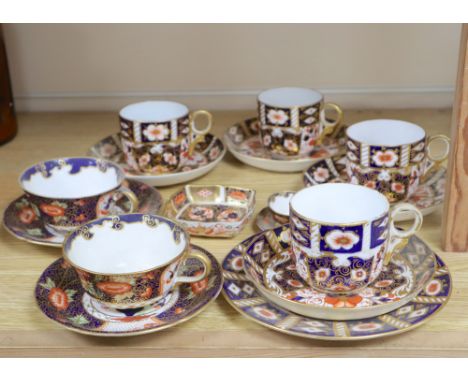 A collection of six Royal Crown Derby cups and saucers, a small square trinket dish and a miniature cup and saucer (16)