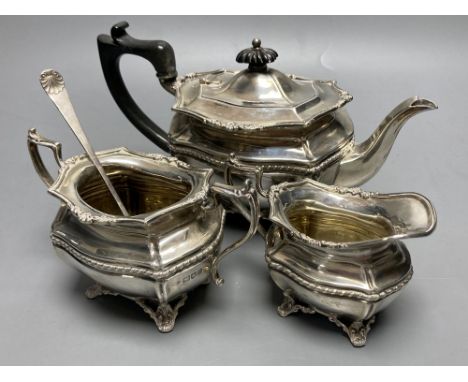 A George V silver bachelor's three piece tea set, Josiah Williams &amp; Co, London, 1913 and a silver pickle fork, gross 20 o